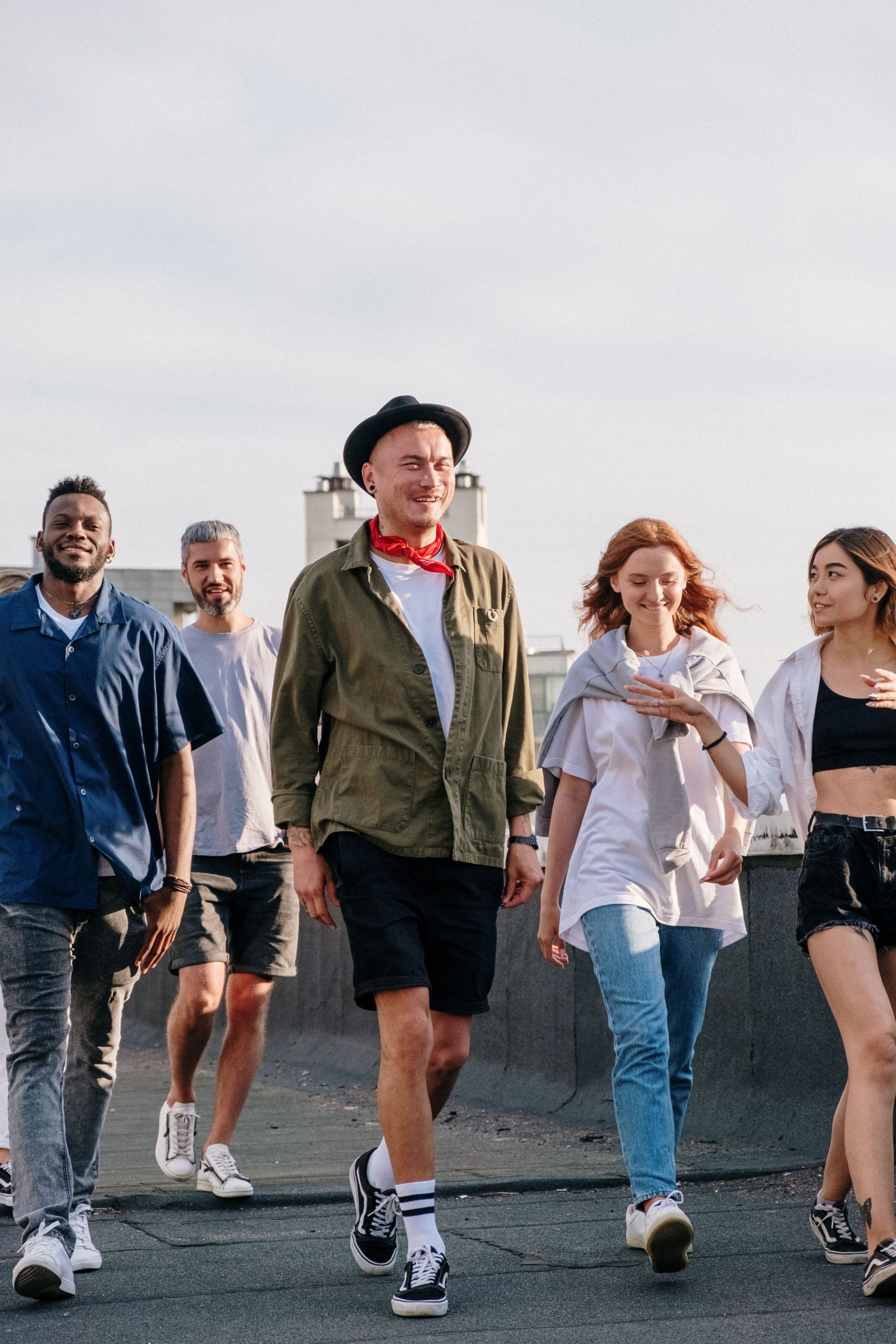 A lively group of friends walking together on a rooftop, capturing a sense of camaraderie and adventure.